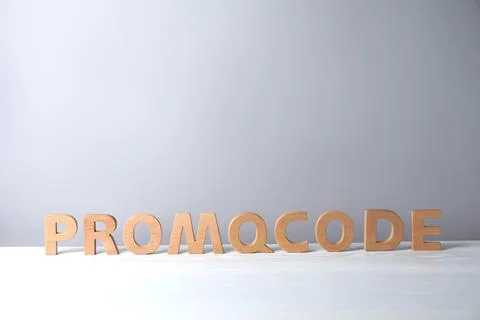 Words Promo Code made of wooden letters on white table, space for text Foto stock