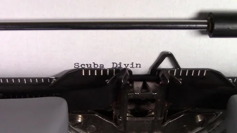 The words "Scuba Diving 101" being typed on a typewriter 스톡 동영상 122891278
