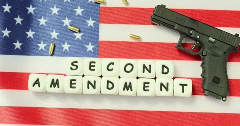 Words Second Amendment made from cubes near gun on USA flag Stock Footage 281378588