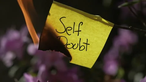 The words "Self Doubt" burning on piece of paper Stock Footage 221375692