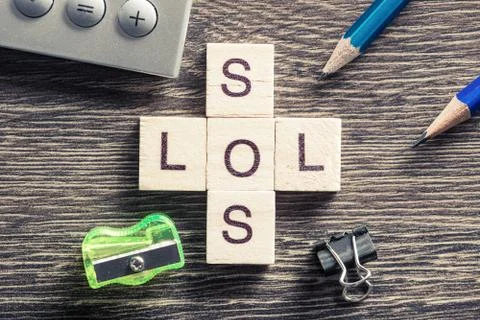 Words SOS and LOL on table made of wooden cubes elements Stock Photos