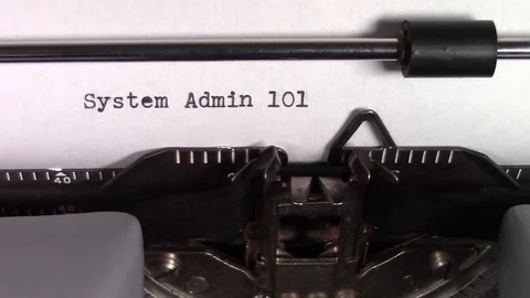 The words "System Administration 101" being typed on a typewriter Stockbeeldmateriaal 122891798
