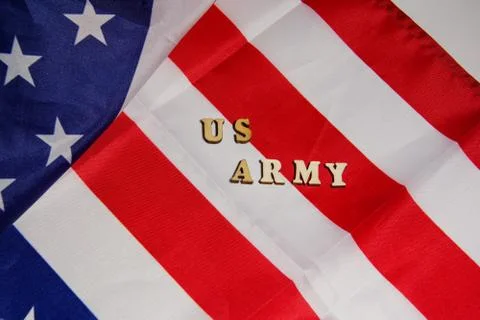 The words US Army written wooden letters on the USA flag background. American Stock Photos