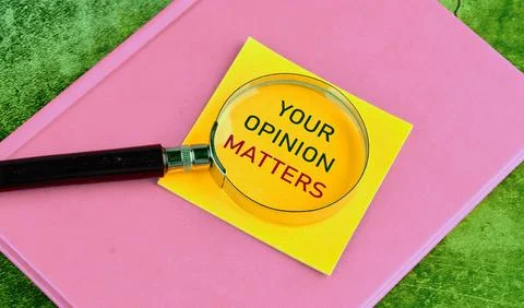 The words YOUR FEEDBACK MATTERS through a magnifying glass on a yellow stic.. Stock Photos