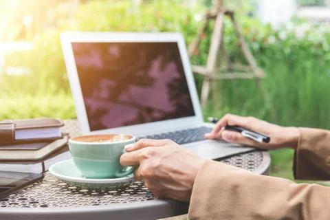 Work and relax, Woman freelancer is working on computer laptop, while sitting Stock Photos