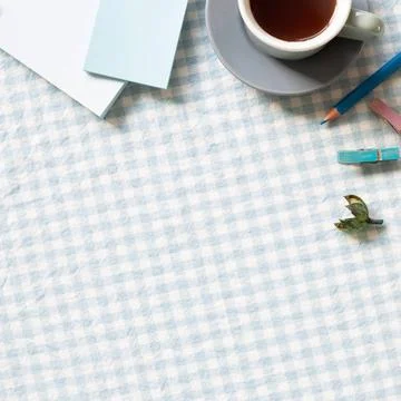 Work and study place. Cup of coffee, notepad, colored pencil, clip on blue... Stock Photos