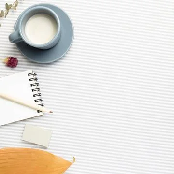 Work and study place. Notebook, cup of milk, pencil with dry plant on stri... Stock Photos