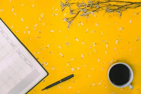 Work area Concept of coffee cups with notes book and pens with white flower.. Stock Photos
