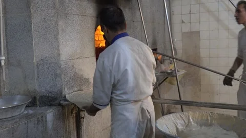 The work of bakers at the bread oven Stockbeeldmateriaal 273100614