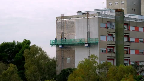 Work is being carred out on a facade of the building using the lifting platform Stock Footage 146483502