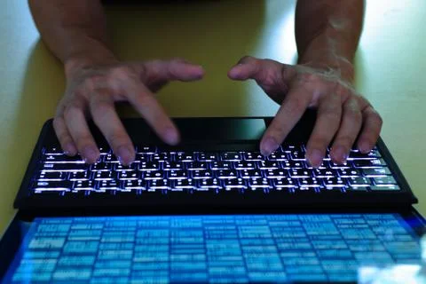 Work with big data. man hands typing on back lit keyboard. laptop monitor scr Foto stock