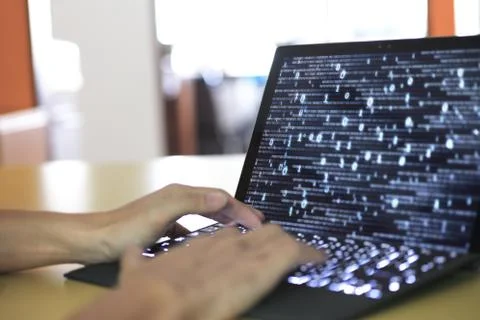 Work with big data. silhouette motion of man typing on back a keyboard. lapto Stock Photos