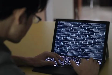 Work with big data. silhouette motion of man typing on back a keyboard. lapto Stock Photos