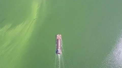 Work boat working crossing a green river. Stock Footage 155403328