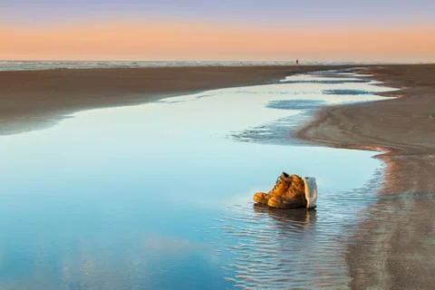 Work boots beach waters Stock Photos