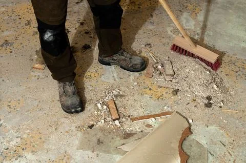 Work boots on concrete floor with construction debris Stock Photos