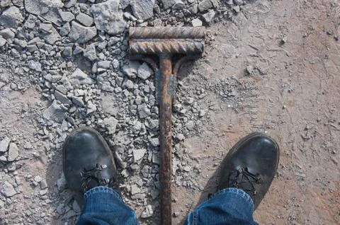 Work boots on a construction background. Protective workwear at a constructio Stock Photos