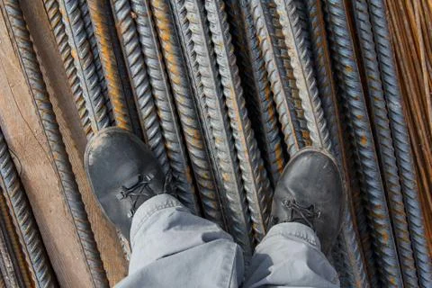 Work boots on a construction background. Protective workwear at a constructio Stock Photos