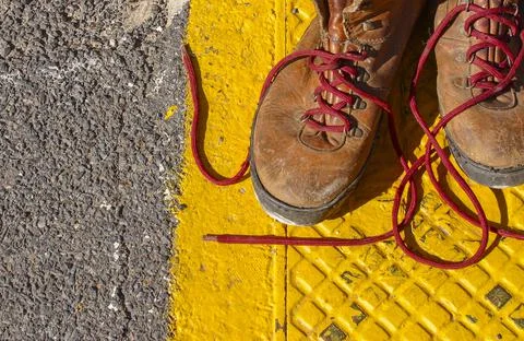 Work boots on a pavement. Stock Photos
