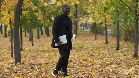 Work break park walk dreamy man laptop autumn Stock Footage 172977723