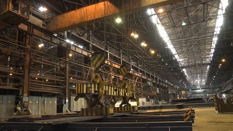 The work of the bridge magnetic crane. Lifting metal rail Stock Footage 106566336