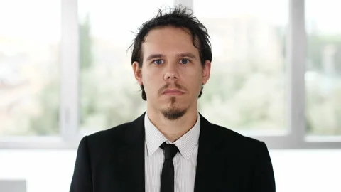 Work, business - young focused manager stares serious at camera Stock Footage 141735642