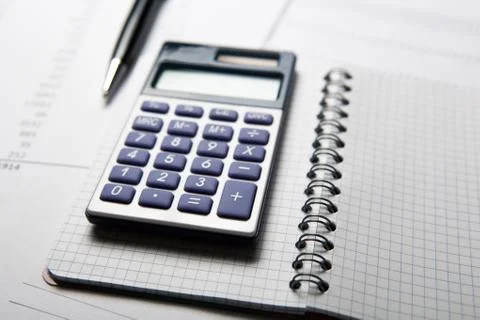 Work on the calculator and papers Stock-Fotos