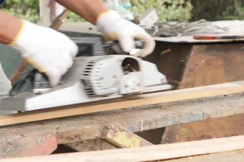 Work carpenter in the workshop. Electric Planer. Stock Footage 65007884