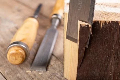 Work with a carpenter's chisel in pine wood. Small carpentry work in the home Stock Photos