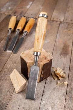 Work with a carpenter's chisel in pine wood. Small carpentry work in the home Stock Photos