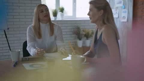 Work with charts. women study transaction reports 4K Stock Footage 120818183