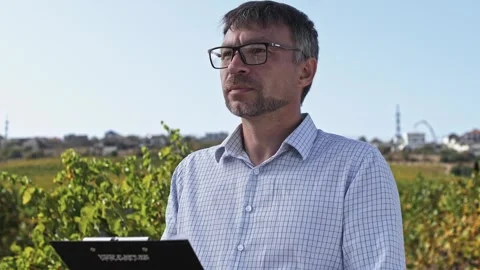 Work of the chief agronomist with a tablet in the field in the vineyard outdoors Stock Footage 270064565