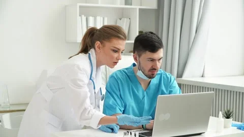 Work of Colleagues doctors in hospital at computer. Coronavirus treatment Stock Footage 148254641