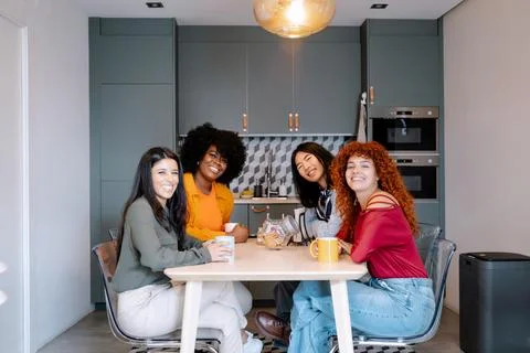 Work colleagues smiling while enjoying having a coffee break together. Fotos de archivo