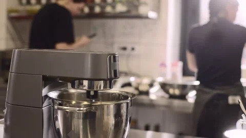 Work of a confectioner. Baking macaroni. Female confectioners work in a modern s Stock Footage 233296423