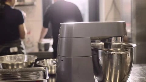 Work of a confectioner. Baking macarons. Female confectioners work in kitchen. Video stock 233296683