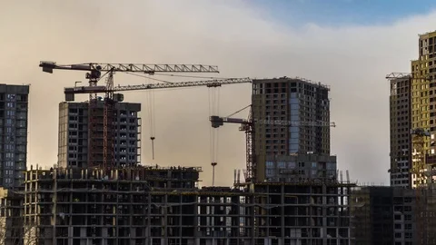 The work of construction cranes on the background of flying clouds,time lapse Stock Footage 125582093