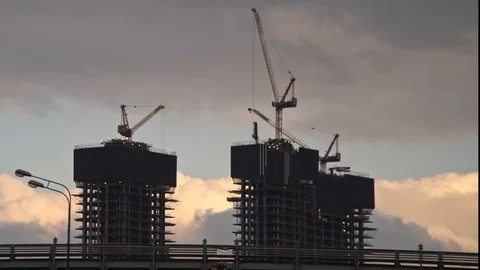 The work of construction cranes on the background of flying clouds, time laps Stock Footage 126057320