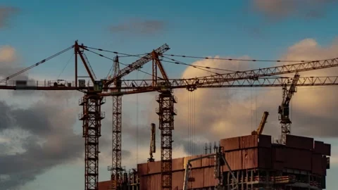 The work of construction cranes on the background of flying clouds, time laps Video stock 154775433