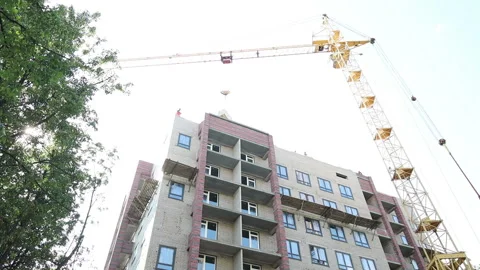 The work of a construction tower crane in the summer on a new building Stock Footage 161185110
