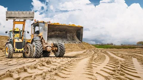 Work continues at the construction site, with two powerful loaders ready fo.. Photos