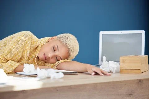 Work, covid and woman at desk sleeping with tissue paper and laptop, tired and Stock Photos