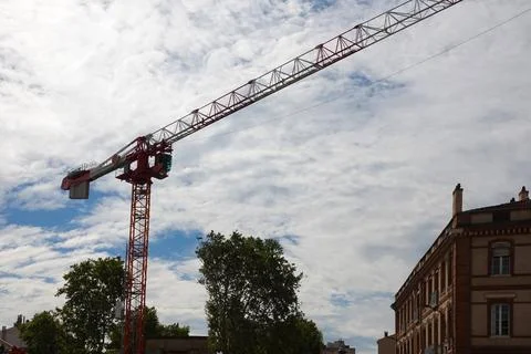Work of crane at construction site in town Stock Photos