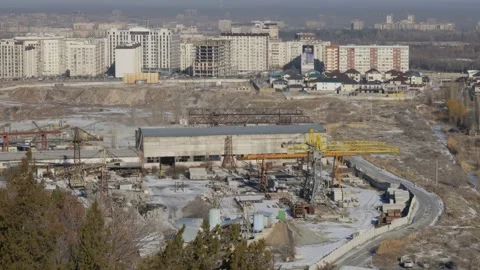Work of cranes and cement trucks in an old factory in winter in Bishkek Stock Footage 226311171