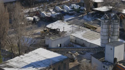 The work of cranes and cement trucks in the old factory in winter. Stock Footage 226311282
