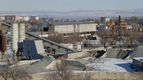Work of cranes and cement trucks in an old factory in winter in Bishkek Stock Footage 226315108