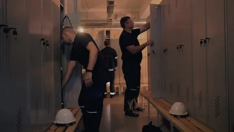 Work crew in the locker room at the plant, gathering before the start Stock Footage 201892009