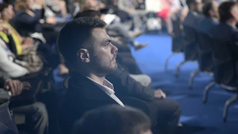 Work of crowded expert forum. Caucasian attractive listener sitting on chair in Video stock 199475713