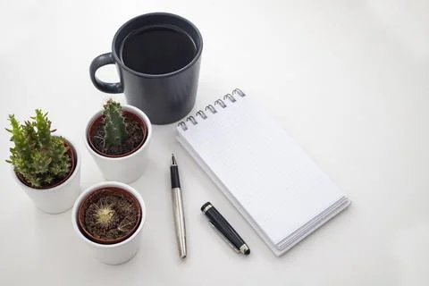Work desk. With coffee, tiny cactus and notepad Stock Photos
