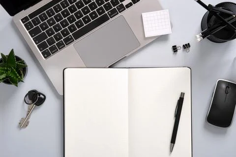 Work desk with computer, notepad, writing supplies. Office table in black and Stock Photos